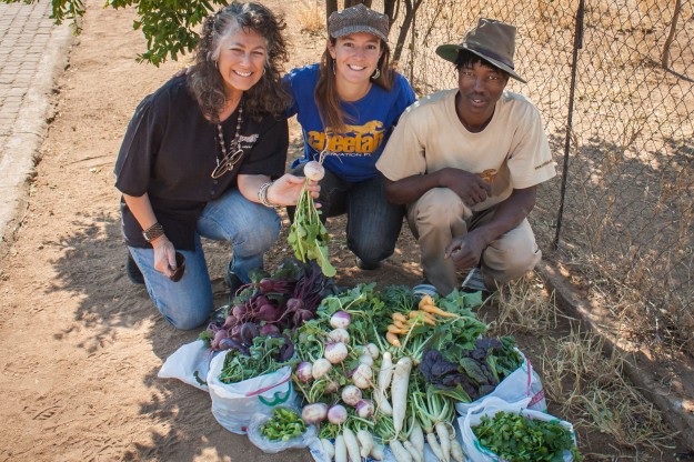 CCF director Laurie, Jenna, and staff gardener Petrus with a recent harvest from the Chewbaaka Memorial Garden